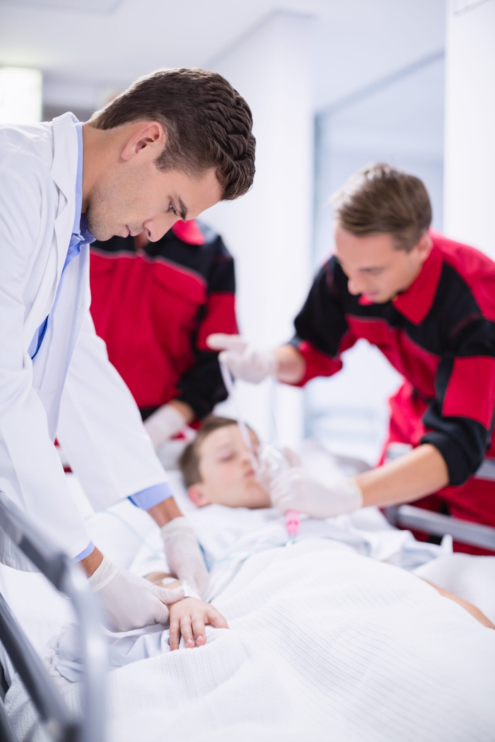 doctors adjusting oxygen mask while rushing the patient in emergency room at hospital